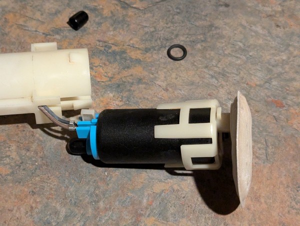 Connecting the wires. The white tab on the black wire locates the pump in the housing. Don't forget the O-ring on the pump outlet.
