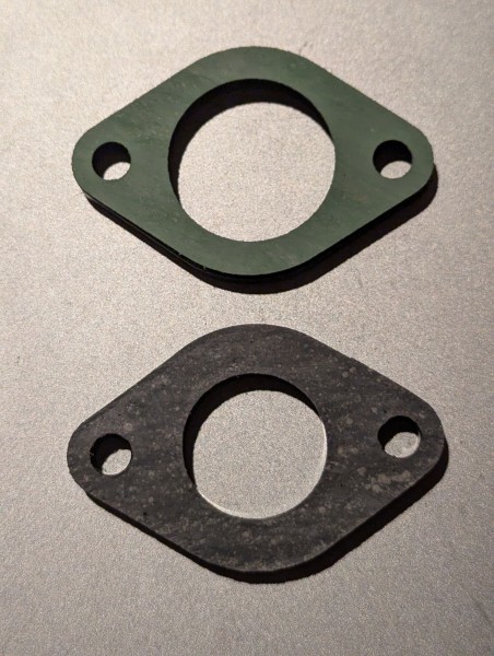 28mm gasket and isolator on top, stock 24mm parts on bottom.